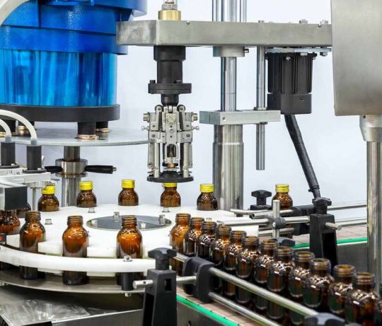 Sterile bottles on the production line conveyor of the pharmaceutical industry. Machine for iquid drugs glassware bottling.