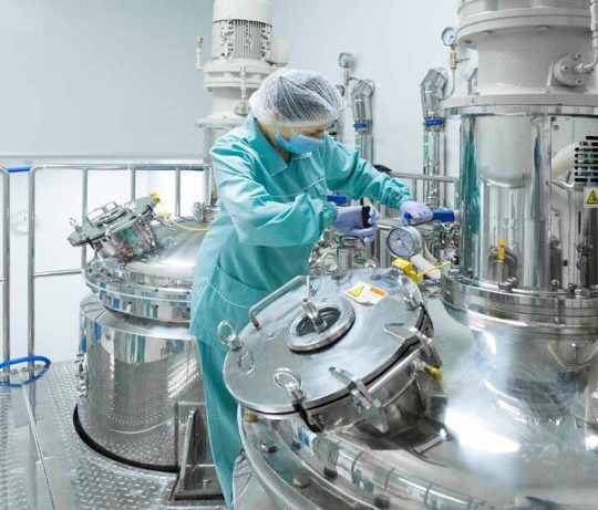 Pharmaceutical technician in sterile environment at pharmacy industry