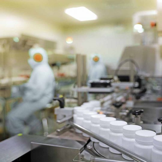 Transfer medicine bottles on the conveyor belt in the pharmaceutical industry, industrial machinery for the quality of medical products. Industrial concept and factory technology.shallow focus effect.